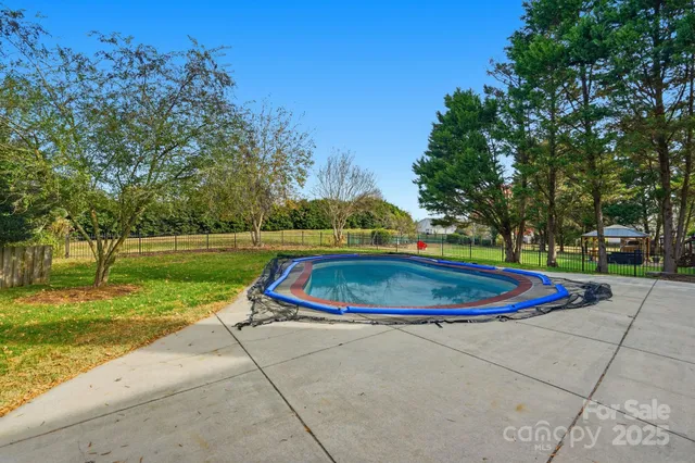 a view of backyard with a deck and floor to ceiling window