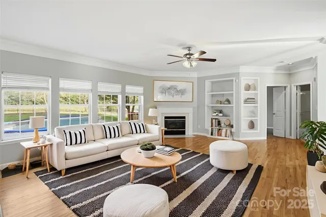 a living room with furniture a fireplace and a table