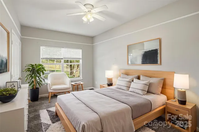 a bedroom with a balcony a bed and a chandelier