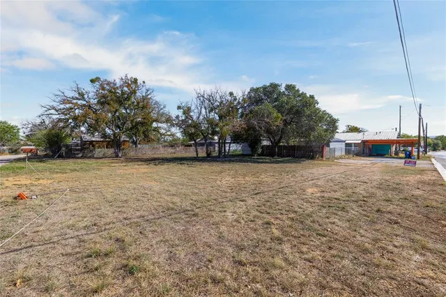 a view of road with large trees