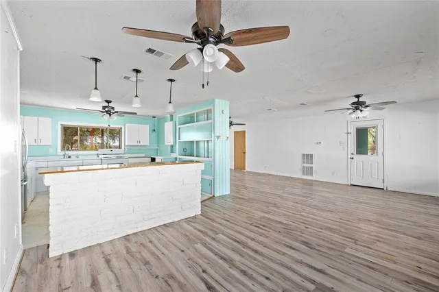 a view of a kitchen with wooden floor