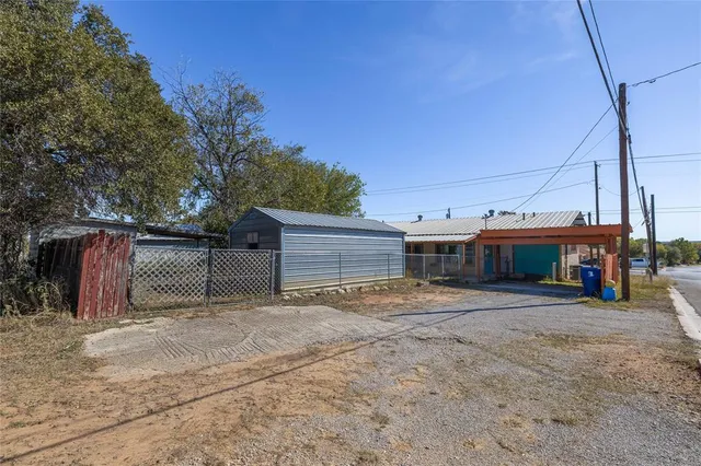 a view of a house with a yard and garage
