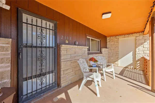 a patio with table and chairs