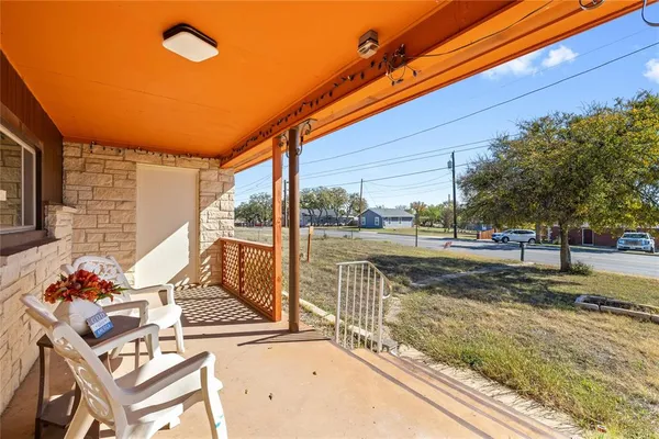 a view of a patio with a table and chairs and potted plants