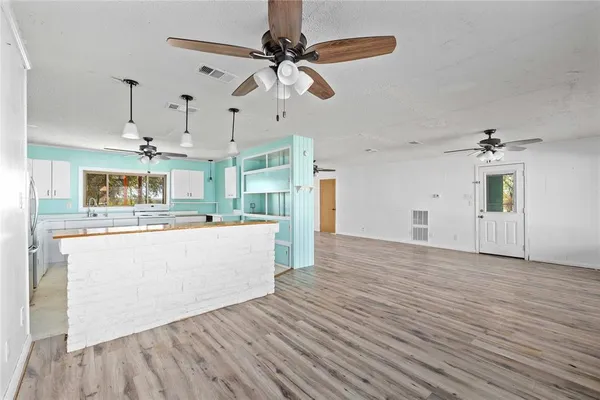 a view of a kitchen with wooden floor