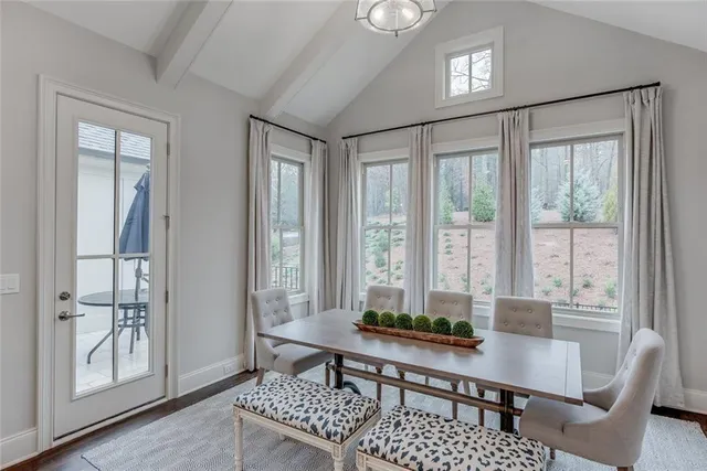 a spacious bedroom with a bed a couch and a large window