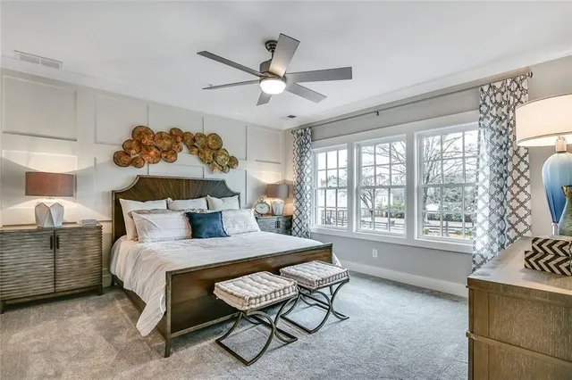 a en suite bathroom with a granite countertop sink and a mirror
