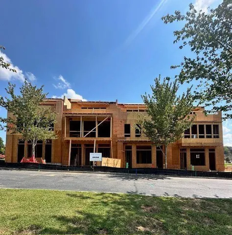 a view of a room with a wooden floor and a ceiling fan