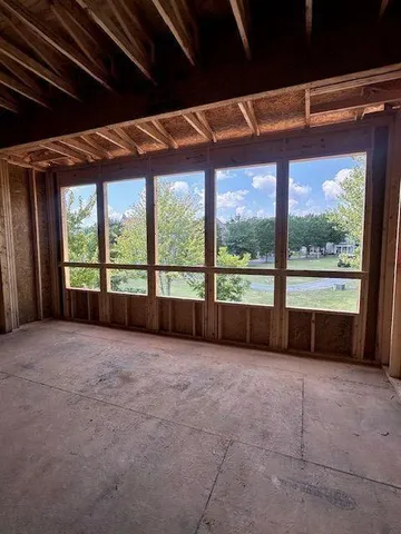 a view of a house with a patio and a yard