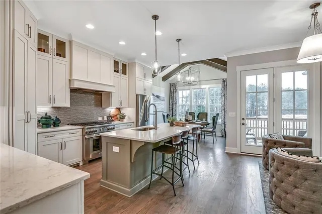 a kitchen with counter space appliances and chairs