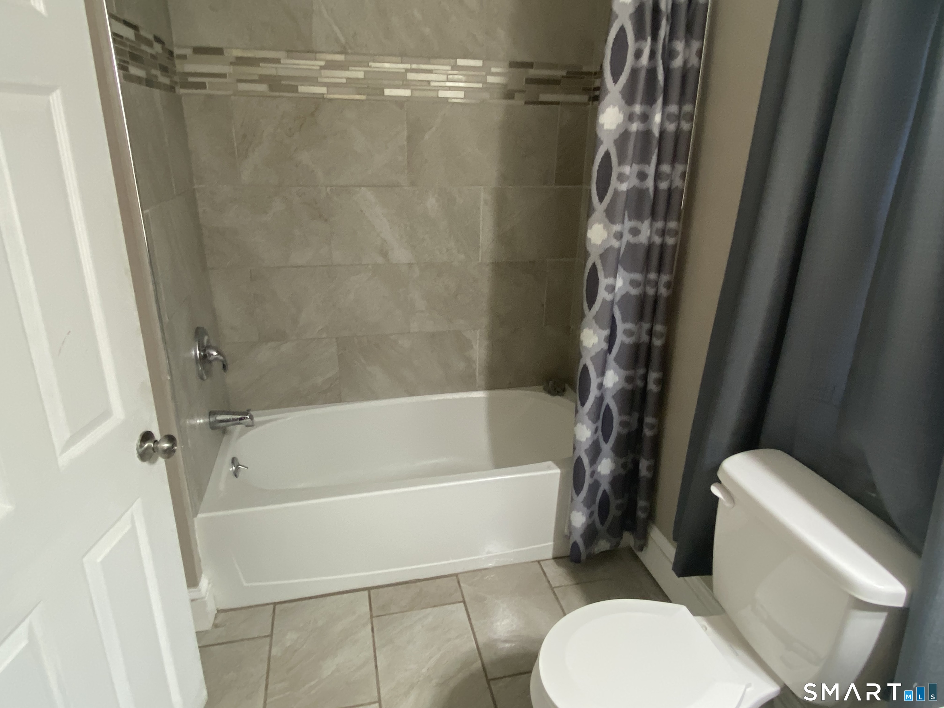 47 Wilson Avenue Windsor, CT 06095 - Photo 11 of 20 a white toilet sitting next to a bath tub