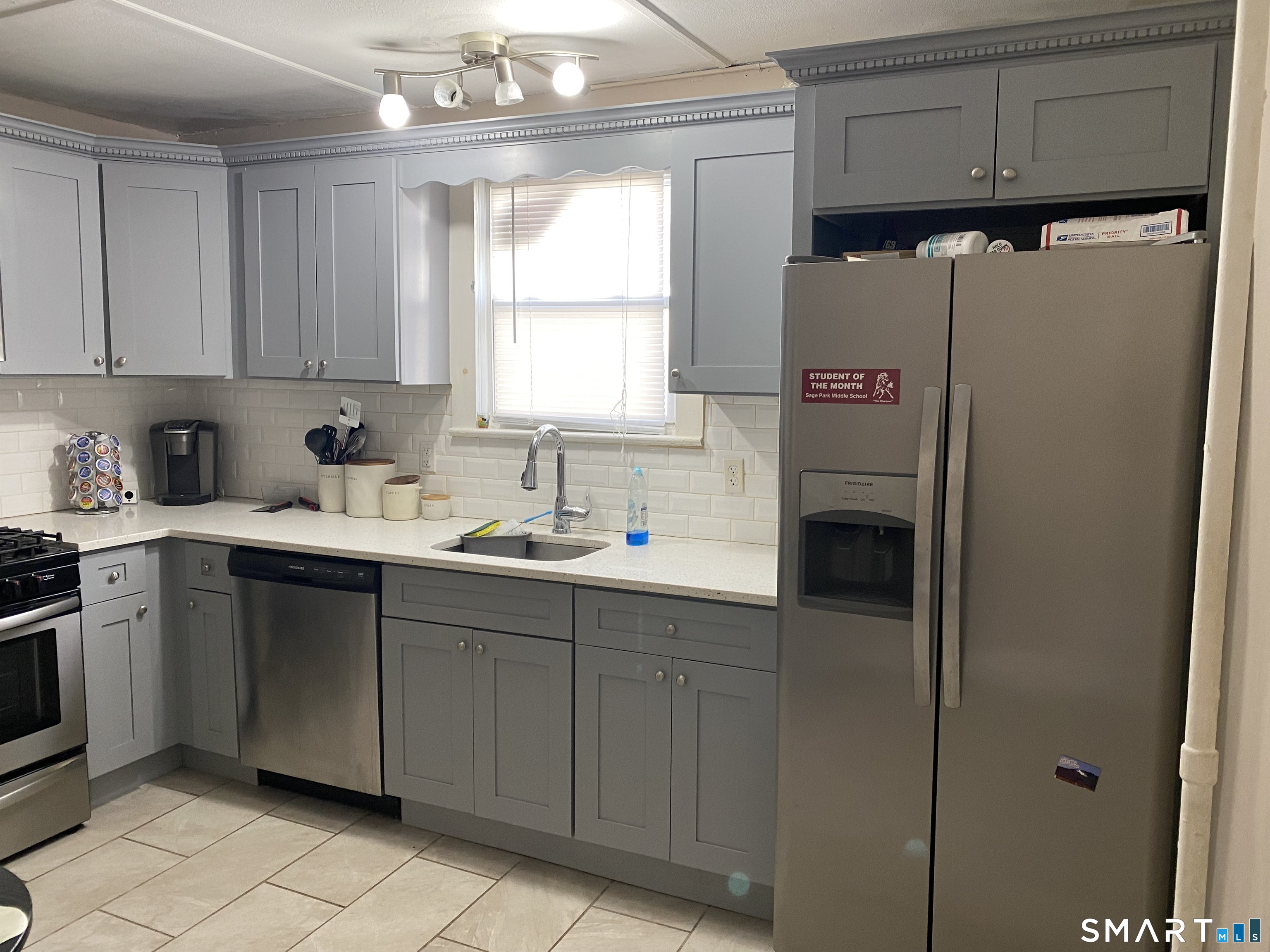 47 Wilson Avenue Windsor, CT 06095 - Photo 6 of 20 a kitchen with a refrigerator sink and cabinets
