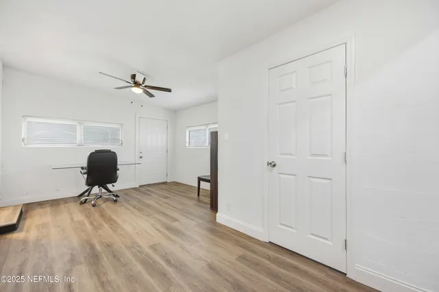a view of a workspace with furniture and a mirror