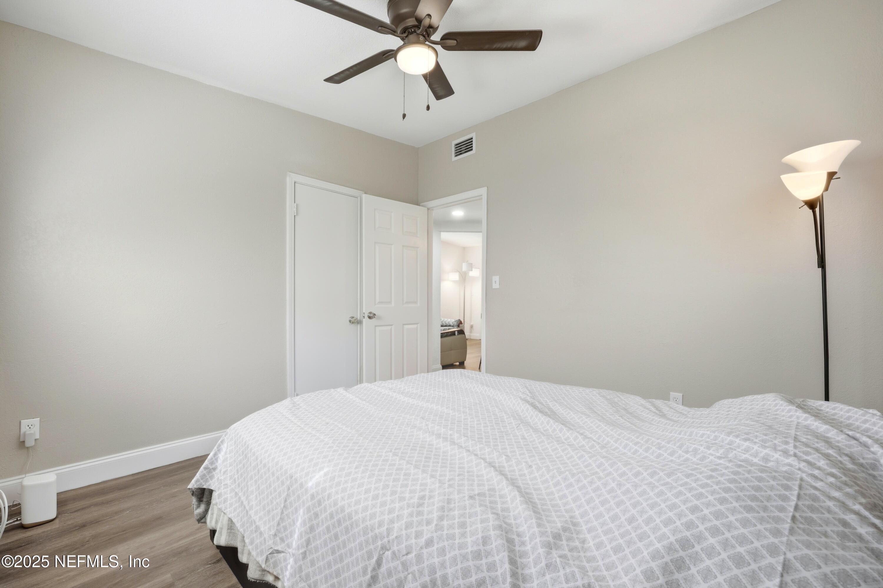 10303 Westmar Road Jacksonville, FL 32218 - Photo 13 of 14 a bedroom with a bed and a chandelier