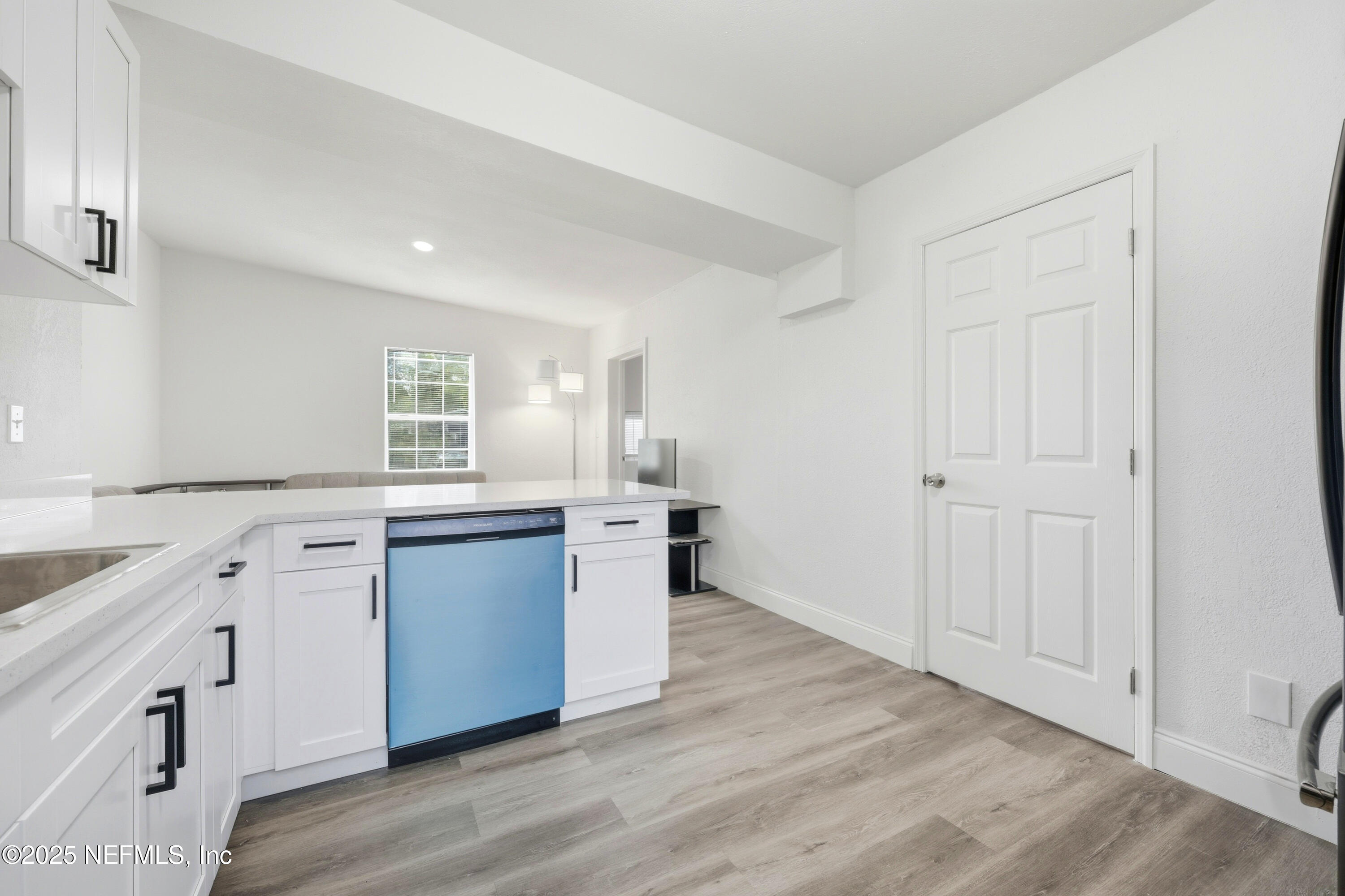 10303 Westmar Road Jacksonville, FL 32218 - Photo 4 of 14 a kitchen with a white wooden cabinets and sink