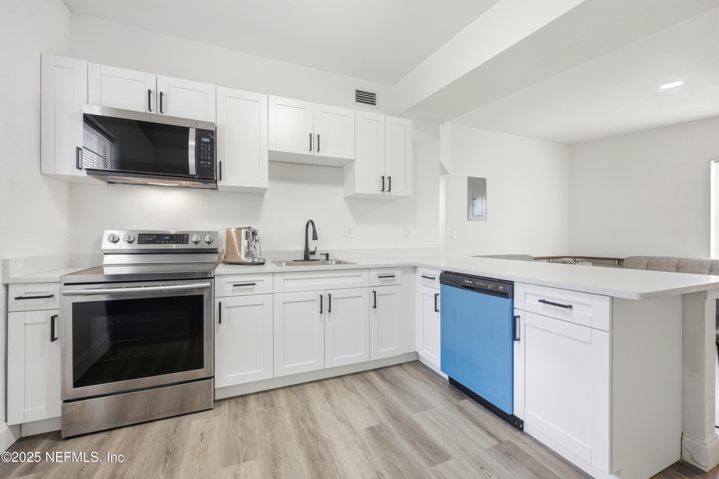 10303 Westmar Road Jacksonville, FL 32218 - Photo 5 of 14 a kitchen with cabinets stainless steel appliances and a sink