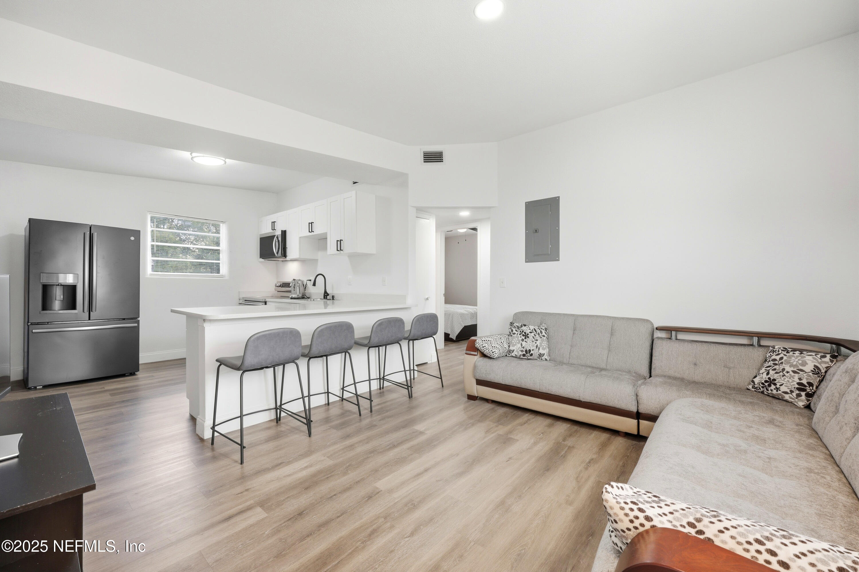 10303 Westmar Road Jacksonville, FL 32218 - Photo 7 of 14 a living room with furniture and a wooden floor