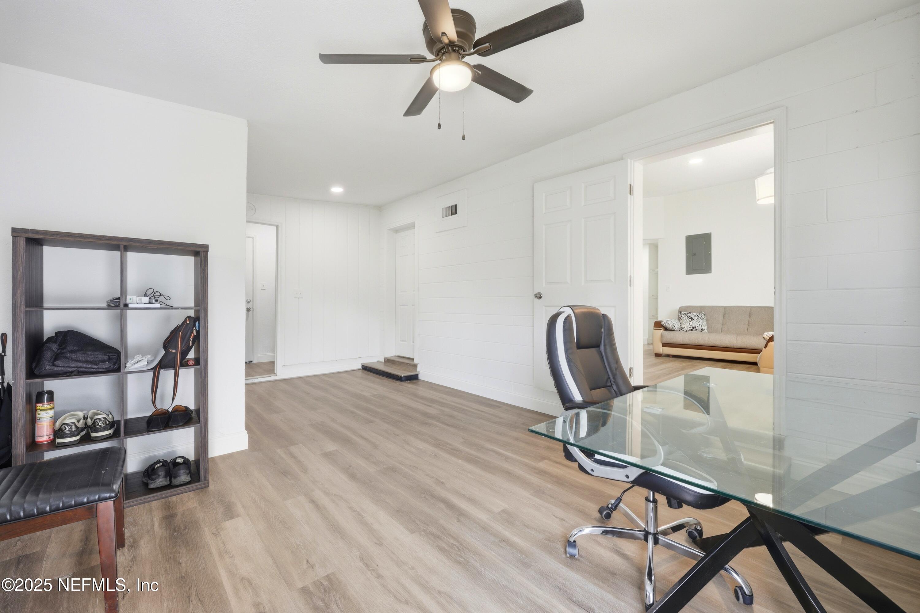 10303 Westmar Road Jacksonville, FL 32218 - Photo 8 of 14 a workspace with furniture and wooden floor