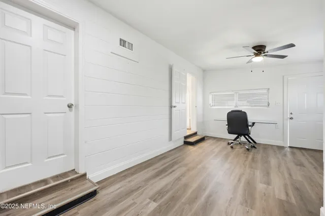 a view of workspace with wooden floor and windows