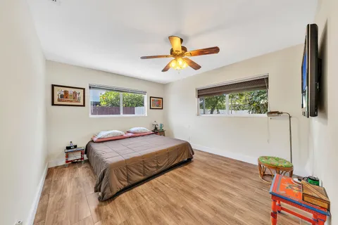 a bedroom with a bed and wooden floor
