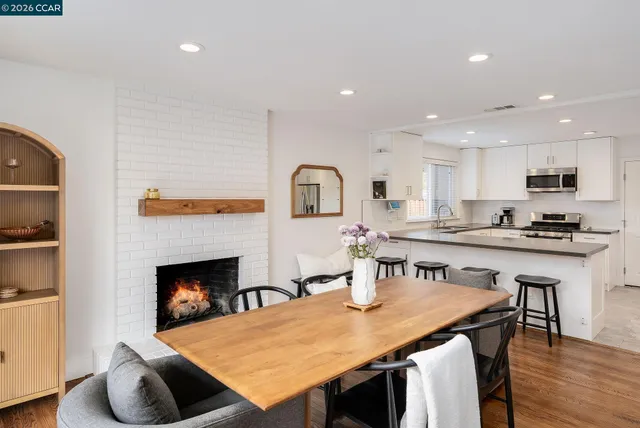 a open kitchen with kitchen island a stove and a wooden floor