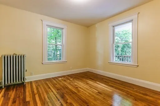 a view of a room with wooden floor and white walls