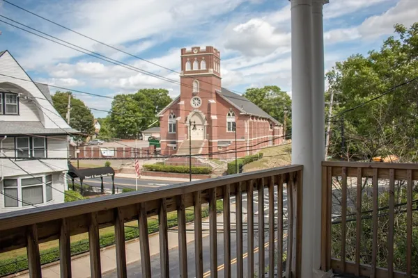 a car parked in front of a white building