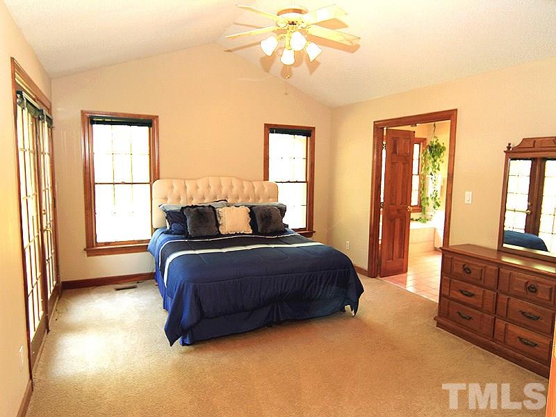 4117 Lassiter Road Wake Forest, NC 27587 - Photo 7 of 22 The large master suite has a huge WIC, private en suite and French door to back deck.