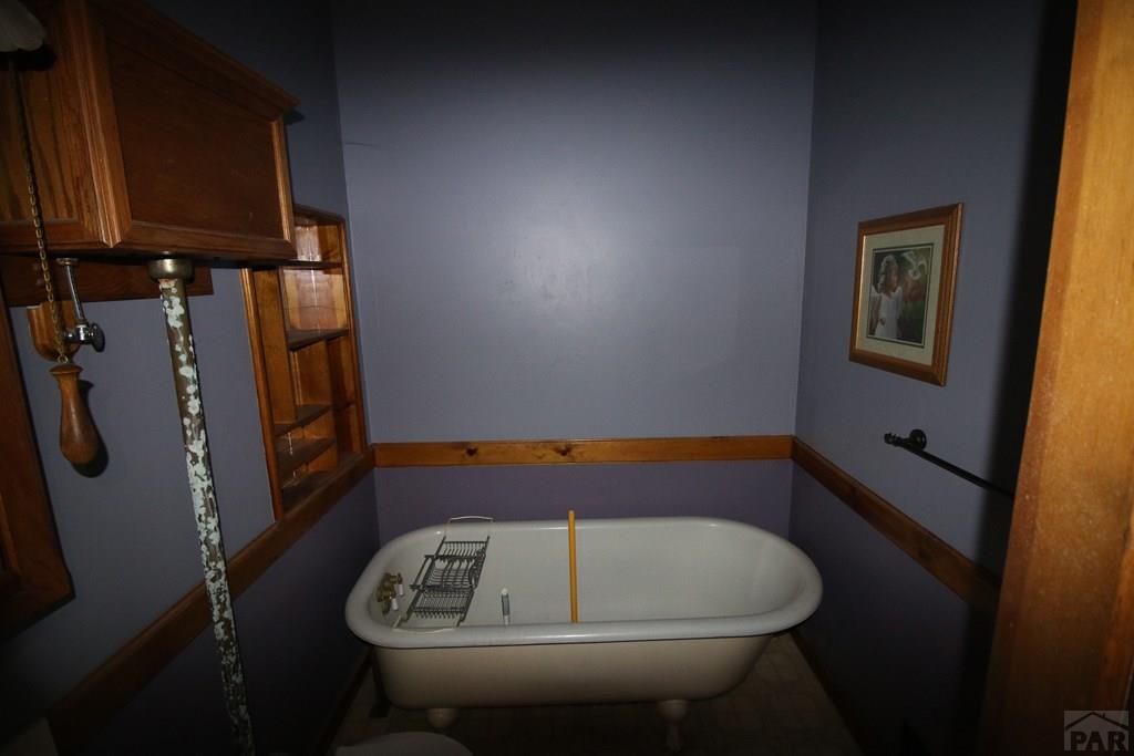 604 South Main Street Fowler, CO 81039 - Photo 17 of 38 a room with water heater and wooden cabinets