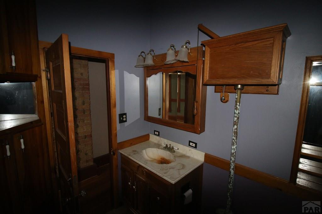 604 South Main Street Fowler, CO 81039 - Photo 19 of 38 a bathroom with a sink and a mirror