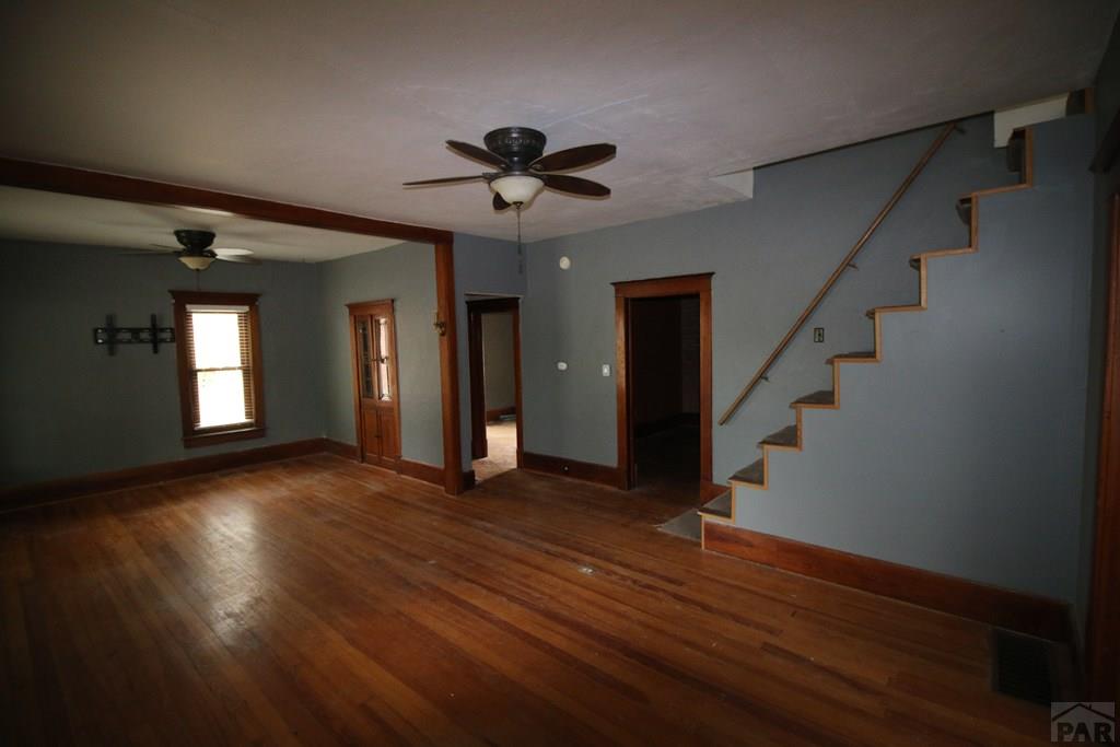 604 South Main Street Fowler, CO 81039 - Photo 2 of 38 a view of an empty room with wooden floor and a ceiling fan