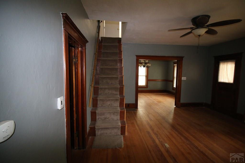 604 South Main Street Fowler, CO 81039 - Photo 4 of 38 a view of a hallway with wooden floor and a bathroom