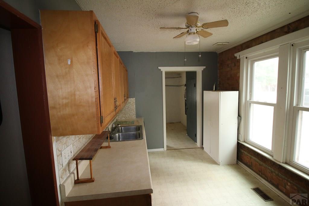 604 South Main Street Fowler, CO 81039 - Photo 7 of 38 wooden floor in an empty room with a window
