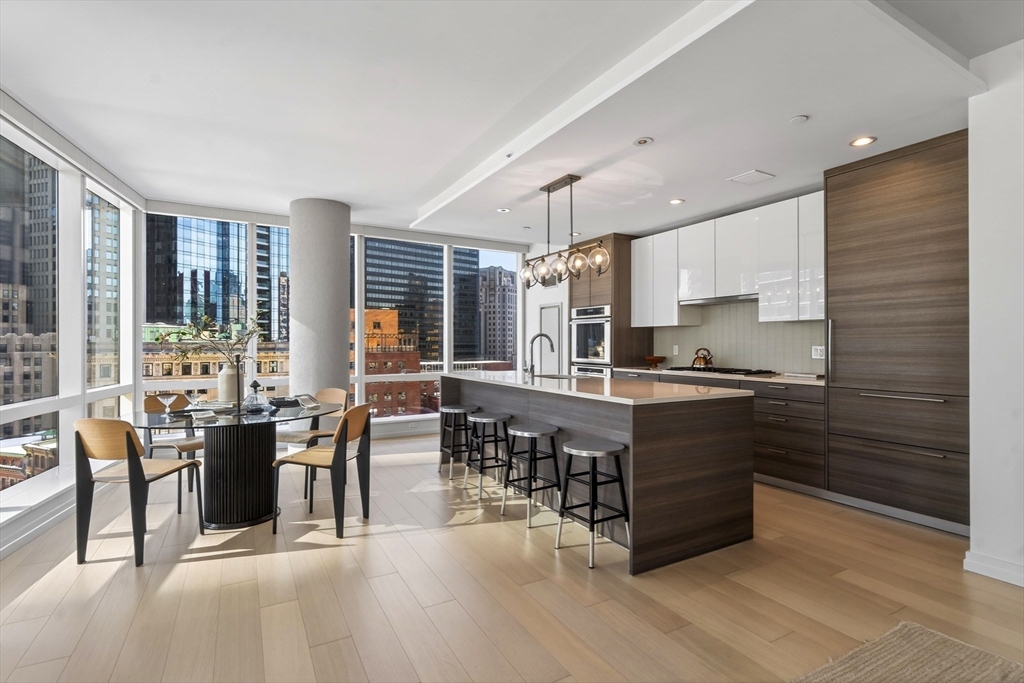 1 Franklin Street, Unit 1408 Boston, MA 02110 - Photo 11 of 37 a kitchen with lots of counter top space and dining table