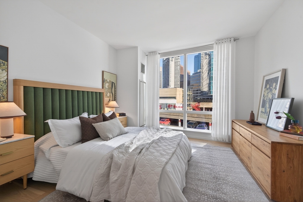 1 Franklin Street, Unit 1408 Boston, MA 02110 - Photo 12 of 37 a bedroom with a bed and a couch