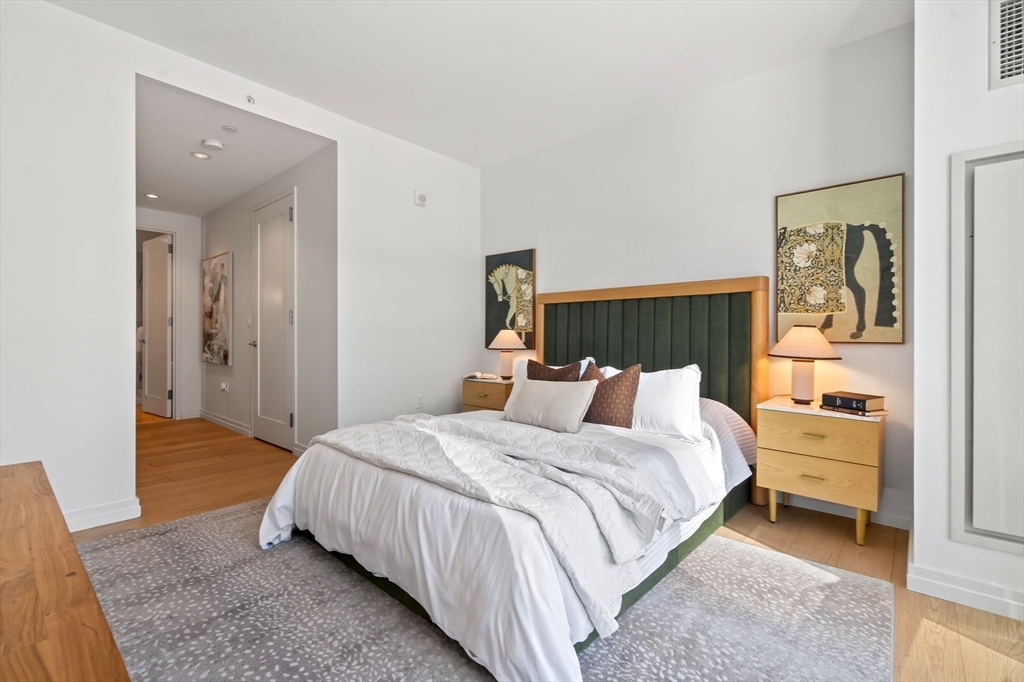 1 Franklin Street, Unit 1408 Boston, MA 02110 - Photo 13 of 37 a bedroom with a bed and a couch