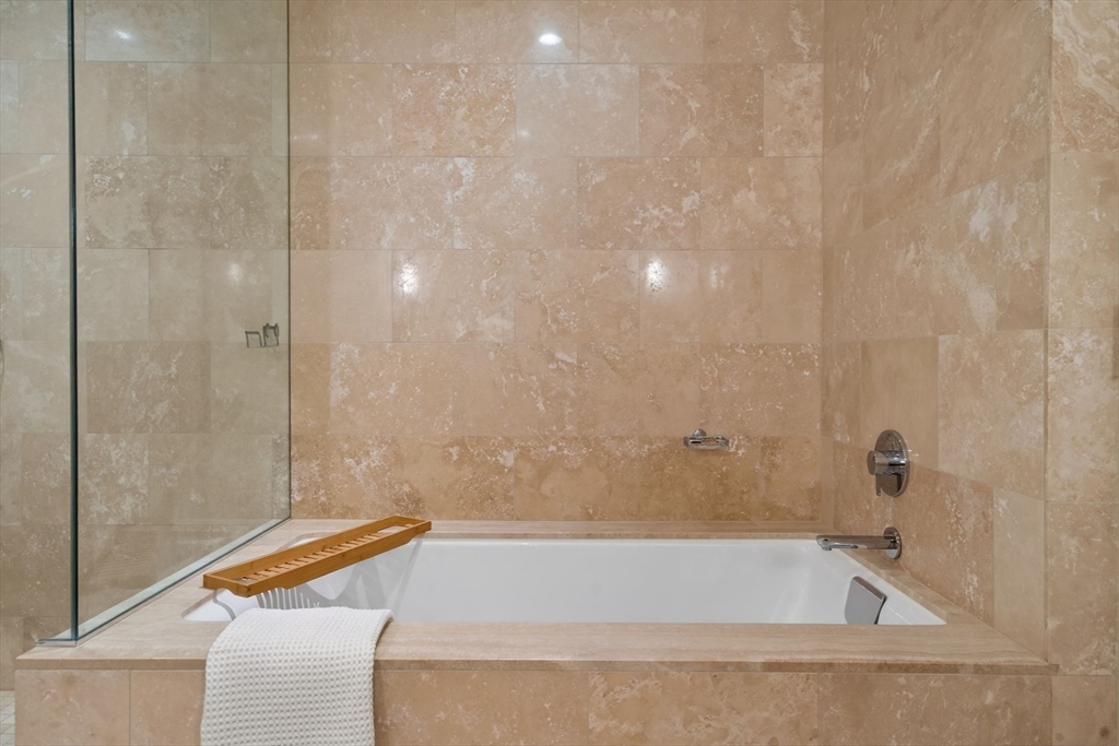 1 Franklin Street, Unit 1408 Boston, MA 02110 - Photo 17 of 37 a bathroom with a bathtub and shower
