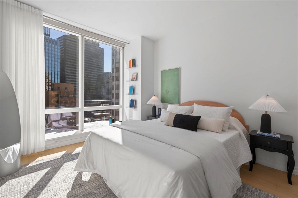 1 Franklin Street, Unit 1408 Boston, MA 02110 - Photo 21 of 37 a bedroom with a large bed and a large window
