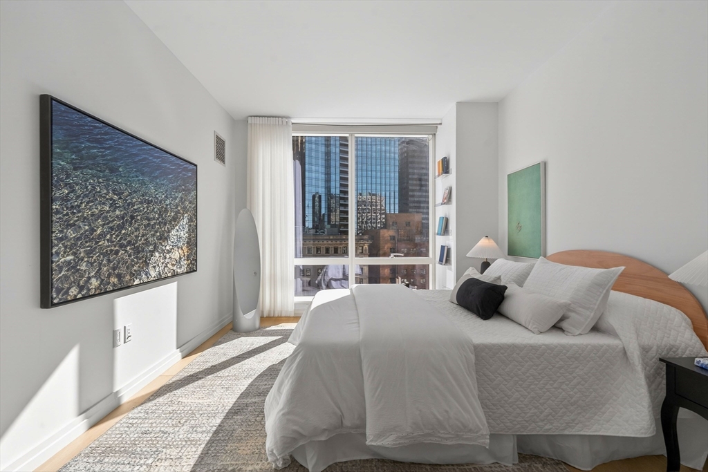 1 Franklin Street, Unit 1408 Boston, MA 02110 - Photo 22 of 37 a bedroom with a bed and a large window