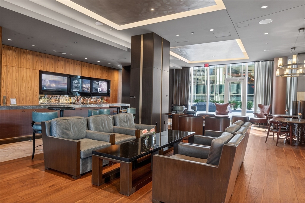 1 Franklin Street, Unit 1408 Boston, MA 02110 - Photo 32 of 37 a living room with furniture and a flat screen tv