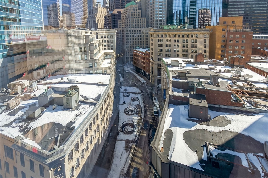 1 Franklin Street, Unit 1408 Boston, MA 02110 - Photo 37 of 37 a balcony with table and chairs