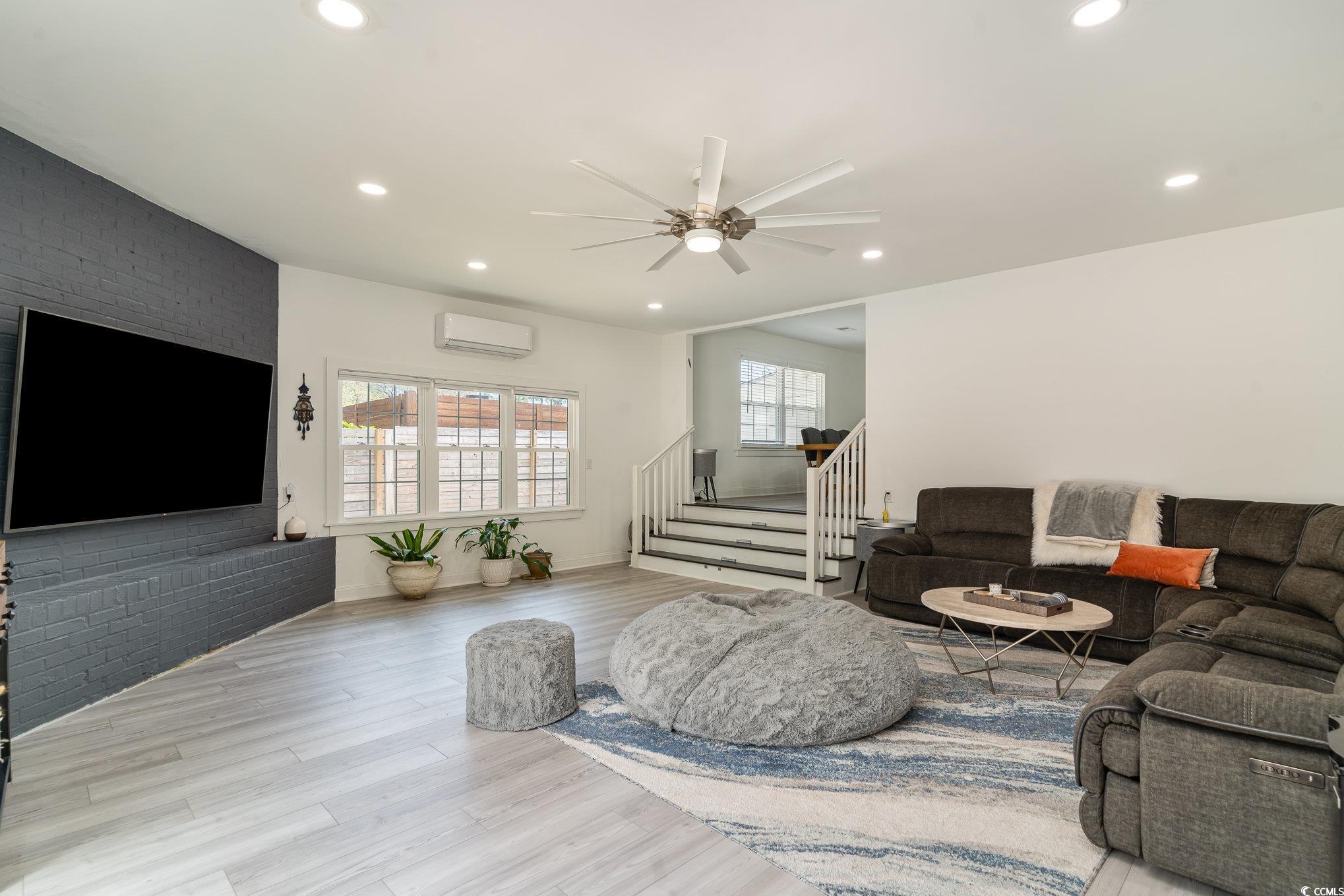 5811 Sumter Drive Myrtle Beach, SC 29577 - Photo 14 of 39 Living area featuring stairway, light wood finished floors, recessed lighting, brick wall, and ceiling fan