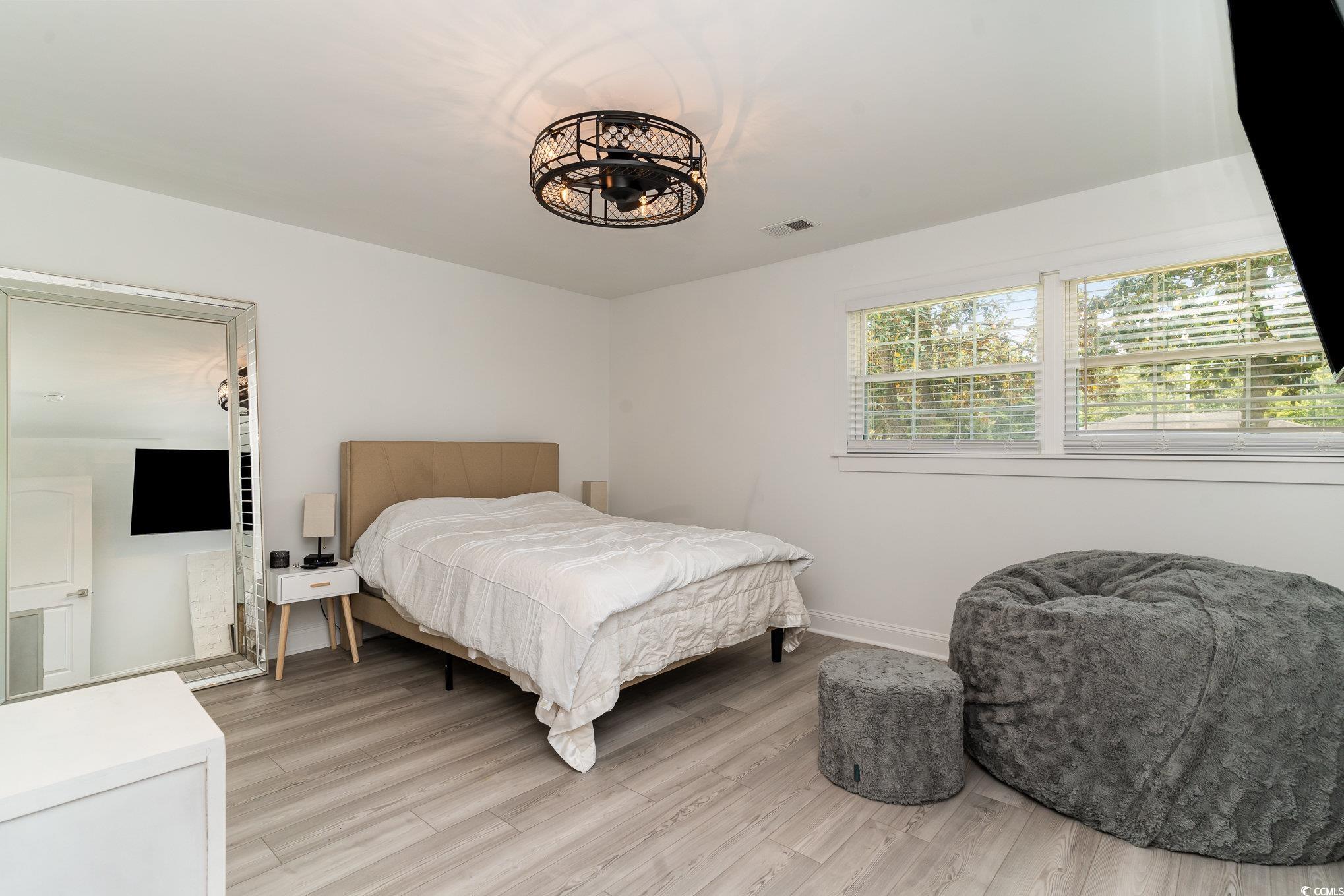 5811 Sumter Drive Myrtle Beach, SC 29577 - Photo 18 of 39 Bedroom with light wood-type flooring and baseboards