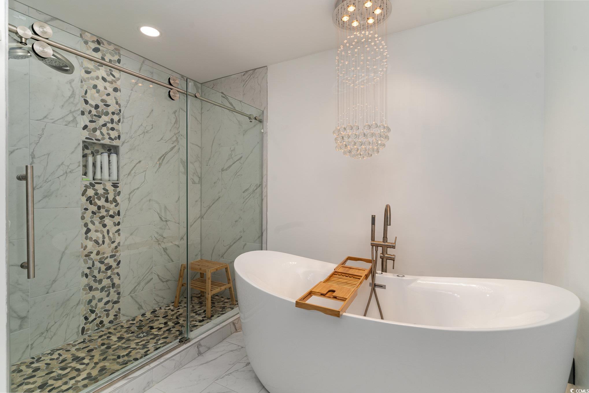 5811 Sumter Drive Myrtle Beach, SC 29577 - Photo 27 of 39 Full bath featuring a chandelier, marble finish floors, a marble finish shower, a freestanding tub, and recessed lighting