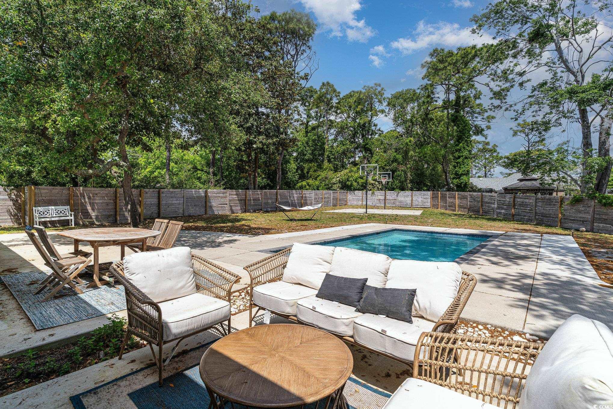 5811 Sumter Drive Myrtle Beach, SC 29577 - Photo 31 of 39 View of swimming pool with a patio area, a fenced backyard, and an outdoor hangout area