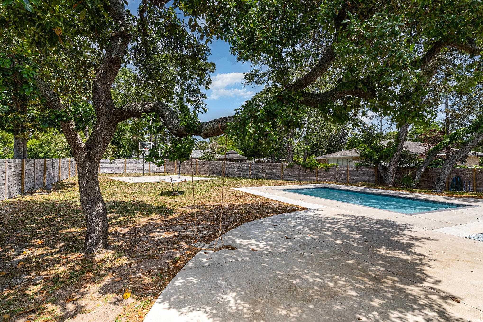 5811 Sumter Drive Myrtle Beach, SC 29577 - Photo 37 of 39 View of swimming pool featuring a fenced backyard and a patio