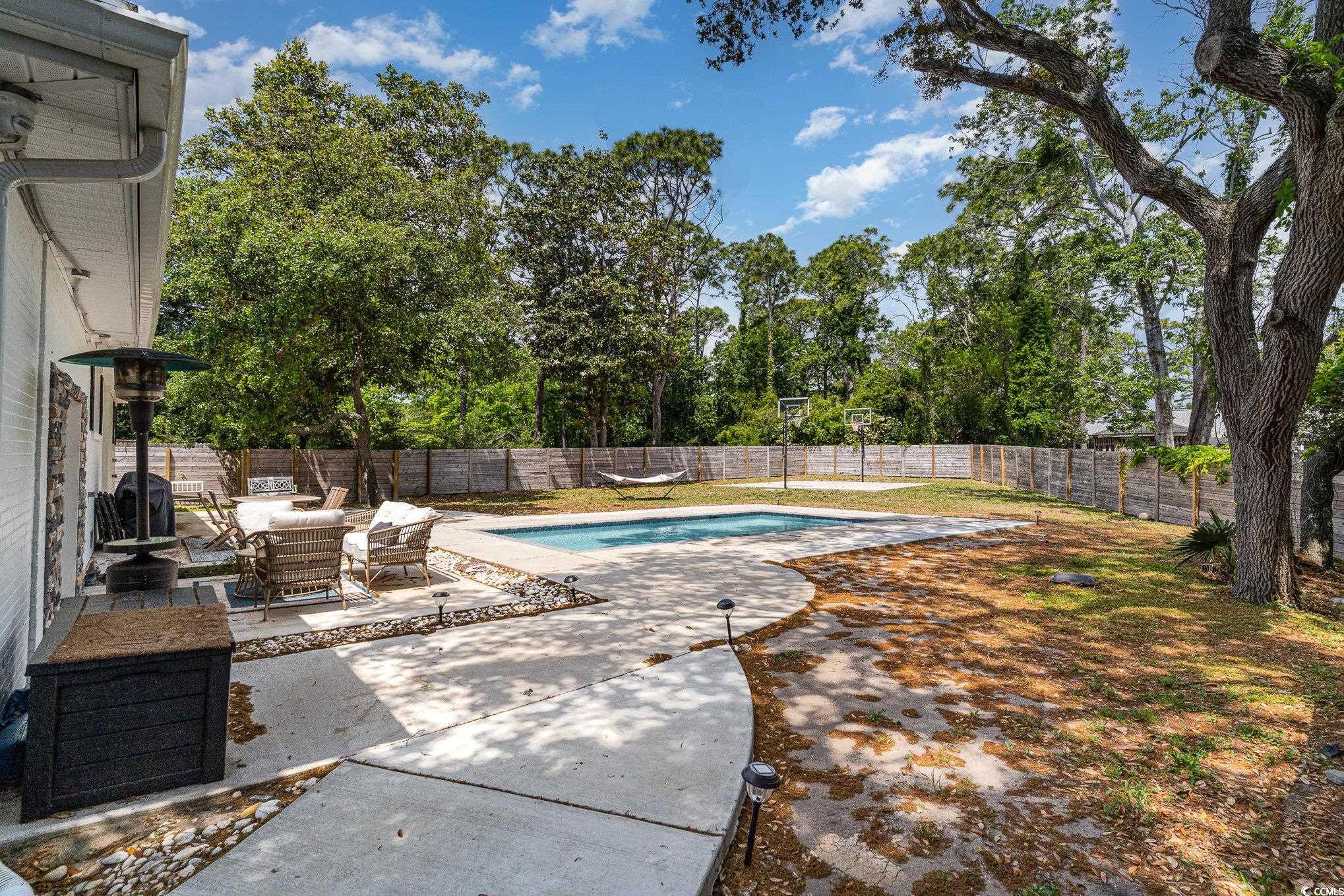 5811 Sumter Drive Myrtle Beach, SC 29577 - Photo 38 of 39 View of pool featuring a patio, a fenced backyard, an outdoor hangout area, and view of scattered trees