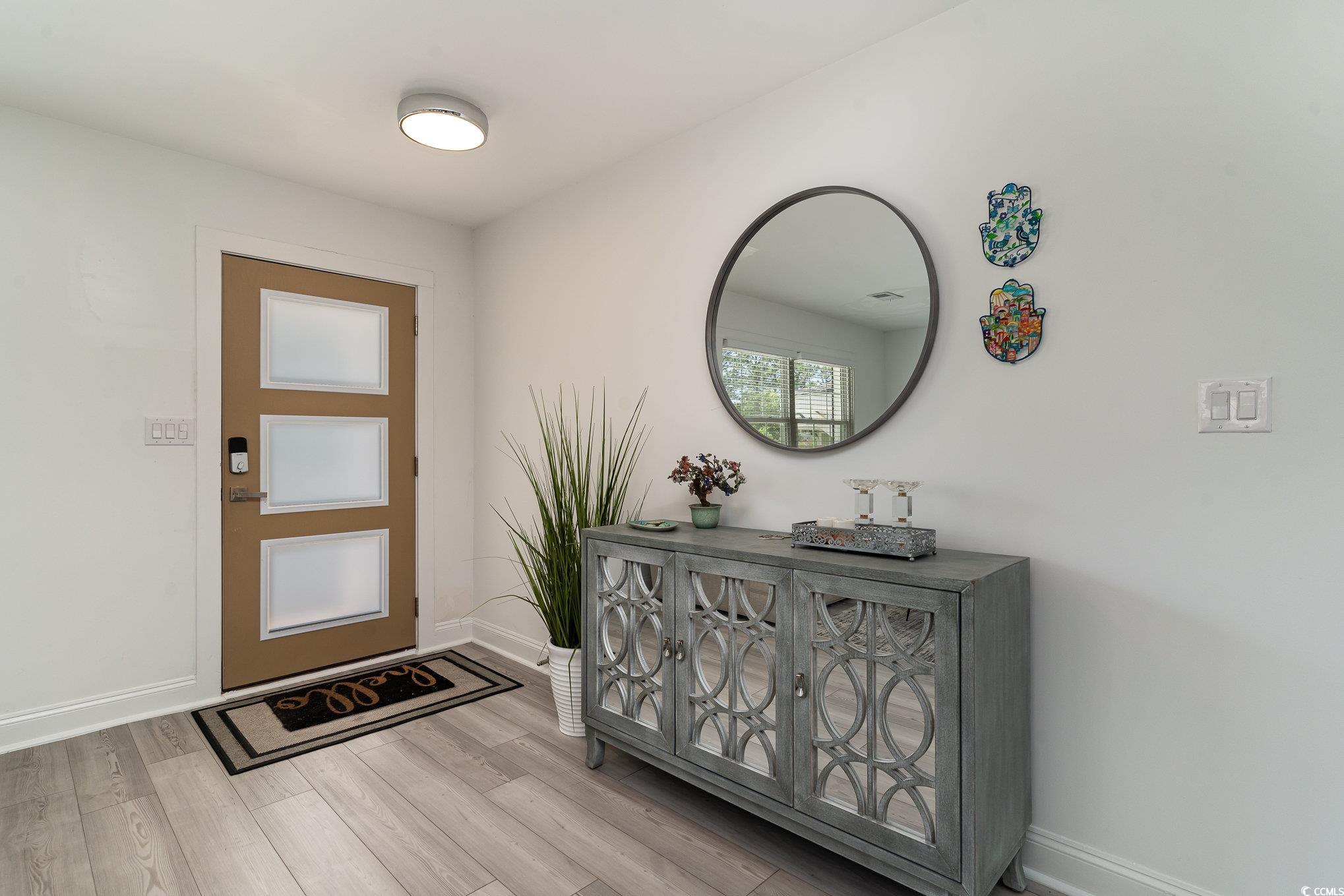 5811 Sumter Drive Myrtle Beach, SC 29577 - Photo 4 of 39 Entryway with baseboards and light wood finished floors