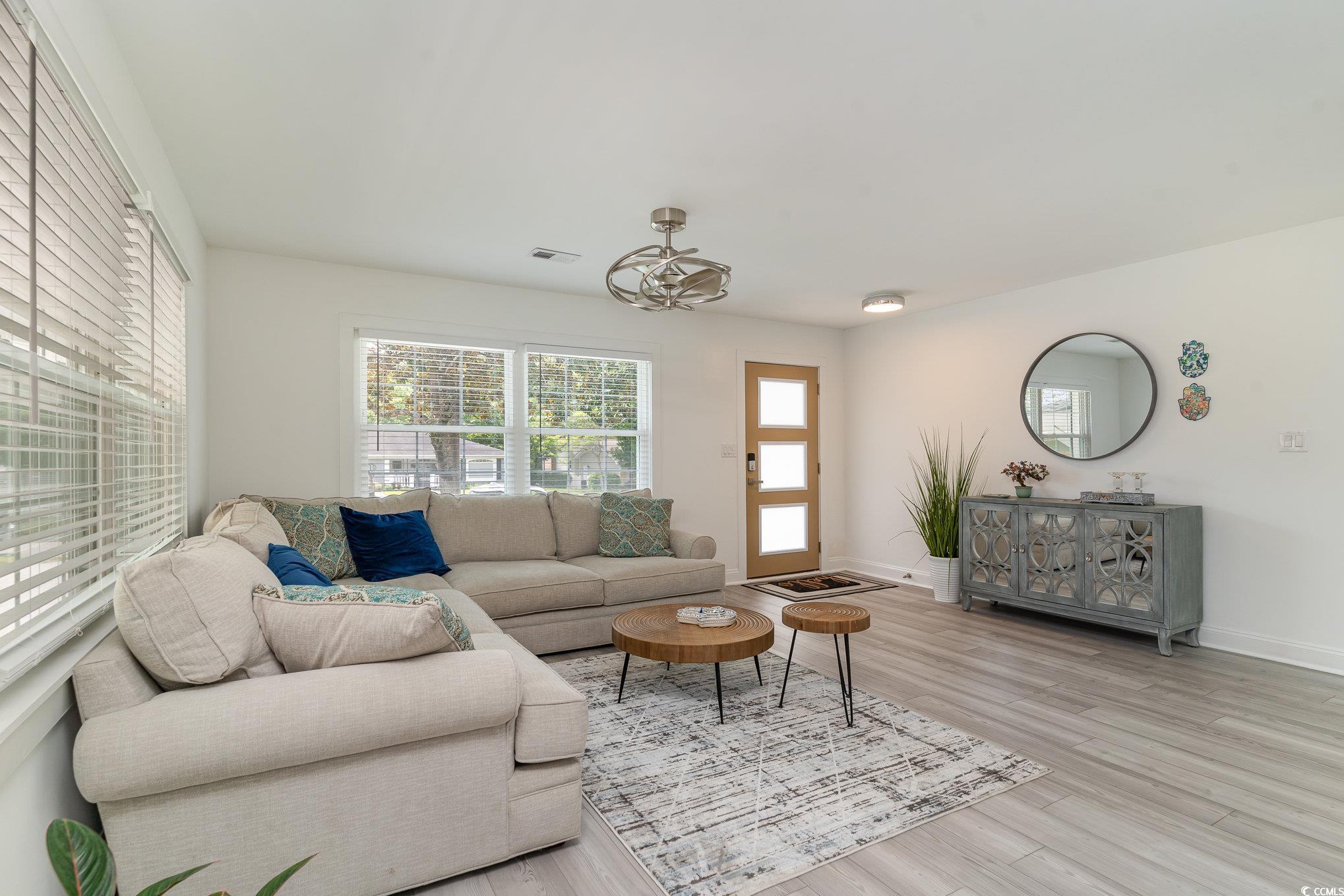 5811 Sumter Drive Myrtle Beach, SC 29577 - Photo 6 of 39 Living room featuring wood finished floors and baseboards