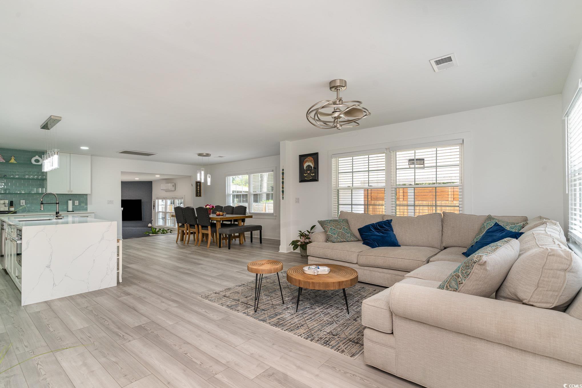 5811 Sumter Drive Myrtle Beach, SC 29577 - Photo 7 of 39 Living area with healthy amount of natural light and light wood-style flooring